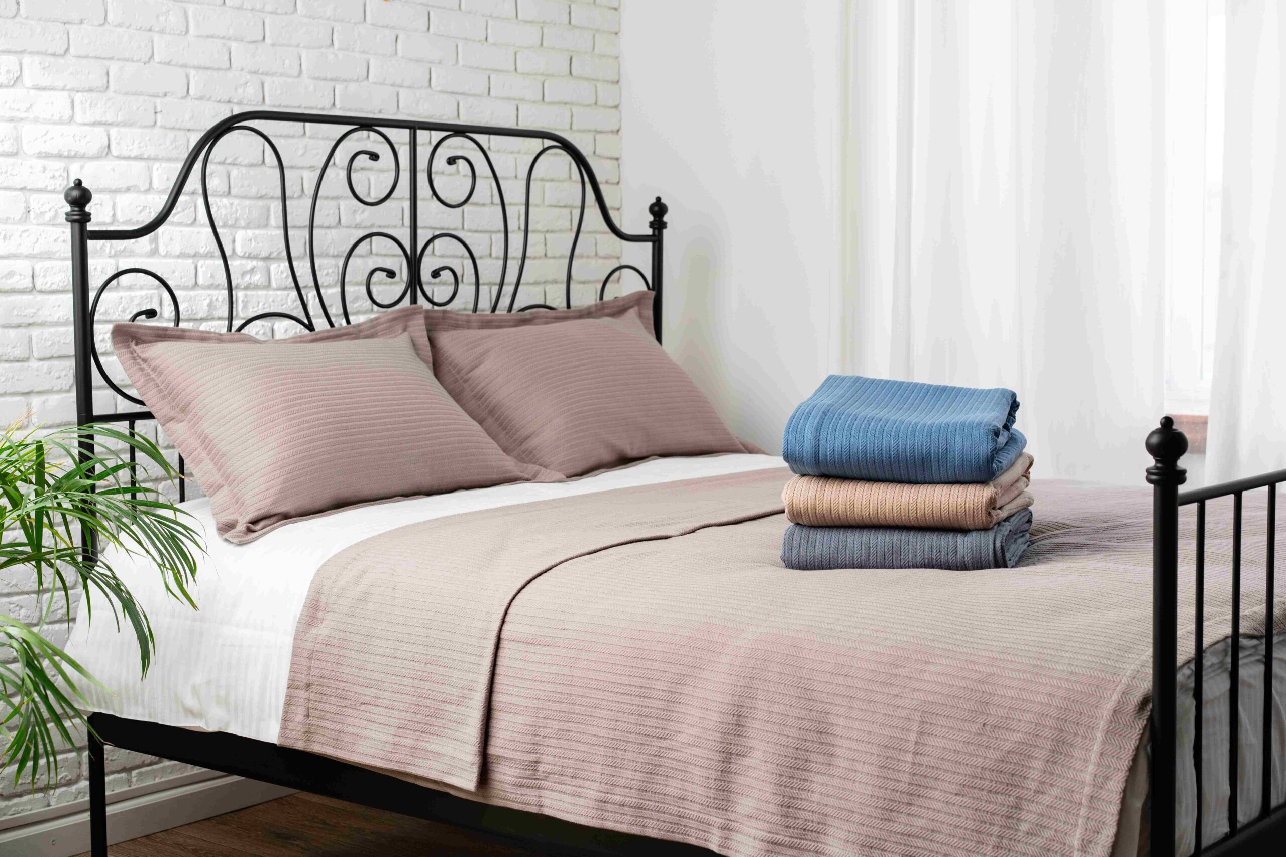 stacked-blue-and-beige-blankets-on-a-made-bed-2025-02-25-08-42-56-utc_11zon