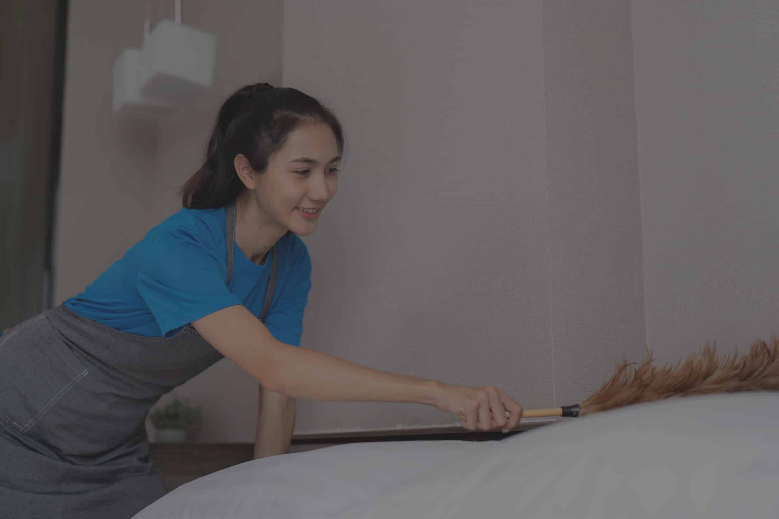 asian-housekeeper-dusting-a-bed-with-a-feather-dus-2025-01-10-12-51-42-utc_11zon