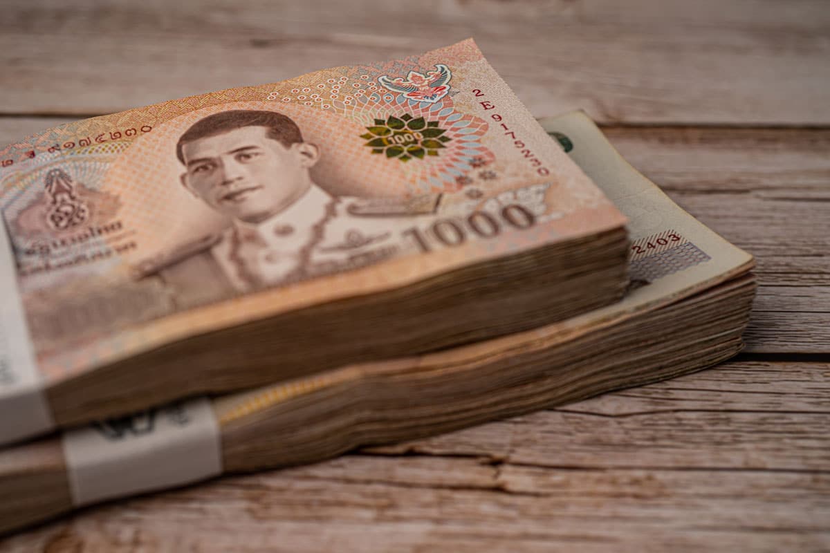 stack-of-thai-baht-banknotes-on-wooden-background-2025-02-24-16-07-57-utc